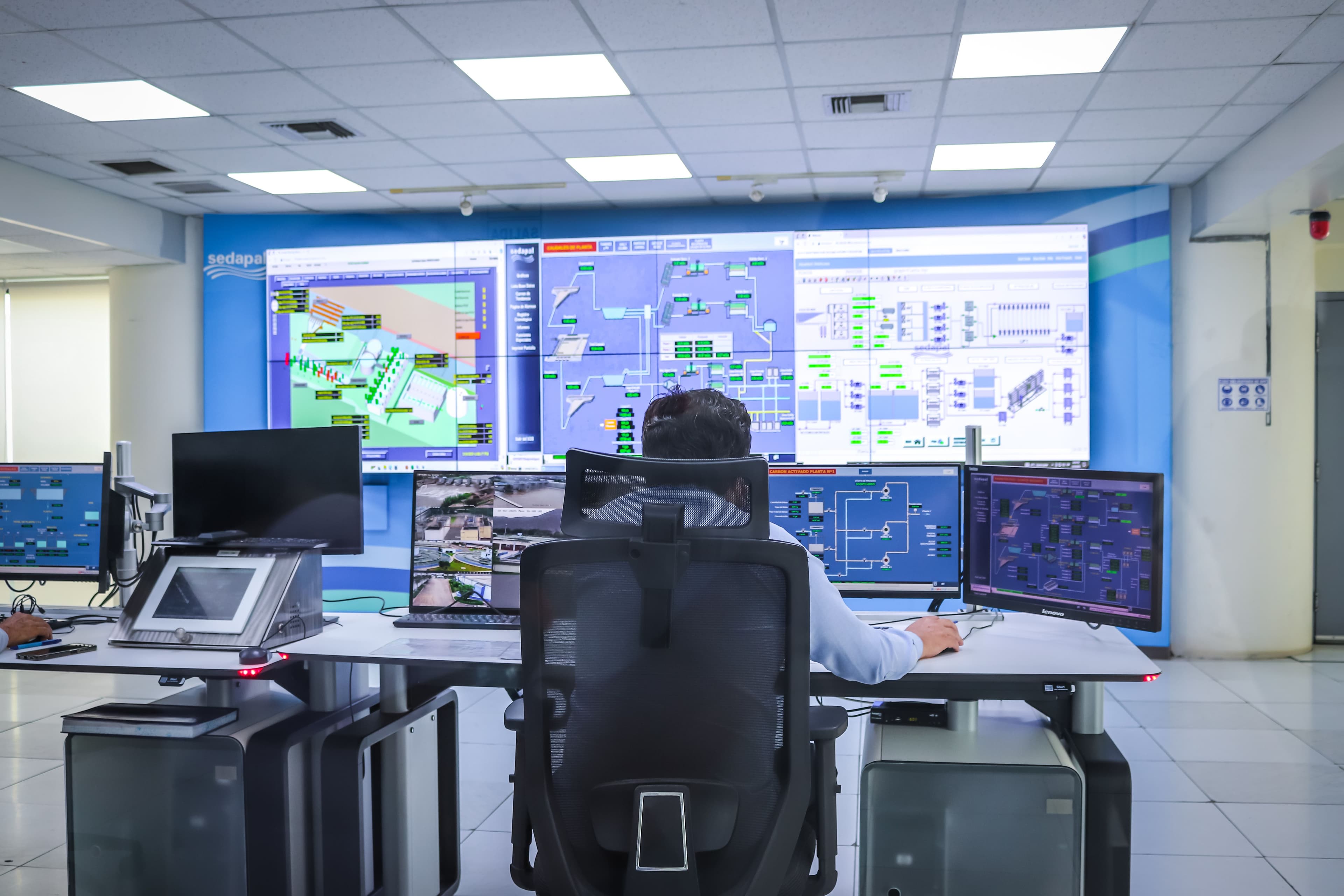 Profesional que supervisa sistemas e indicadores en una sala de control